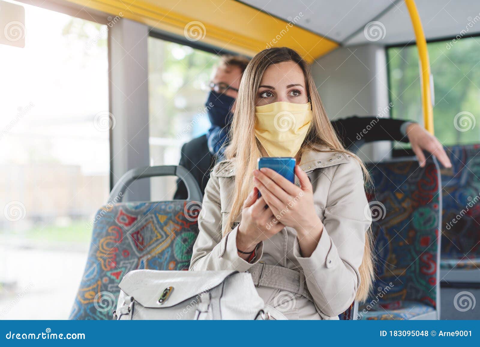People Wearing Masks in the Bus Using Public Transport Stock Photo