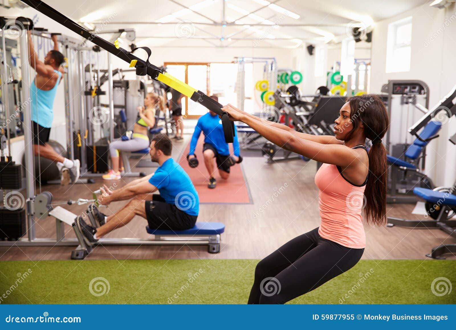 people working out on fitness equipment at a busy gym