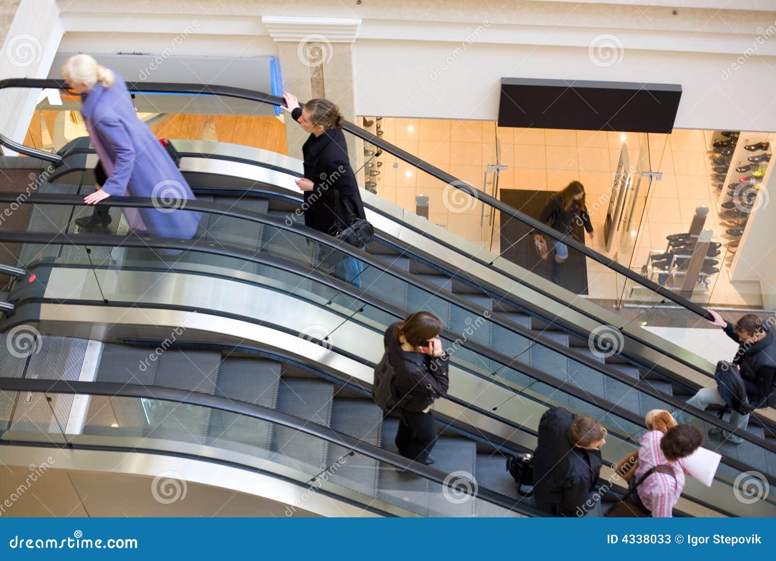 peoples on escalators in a mall