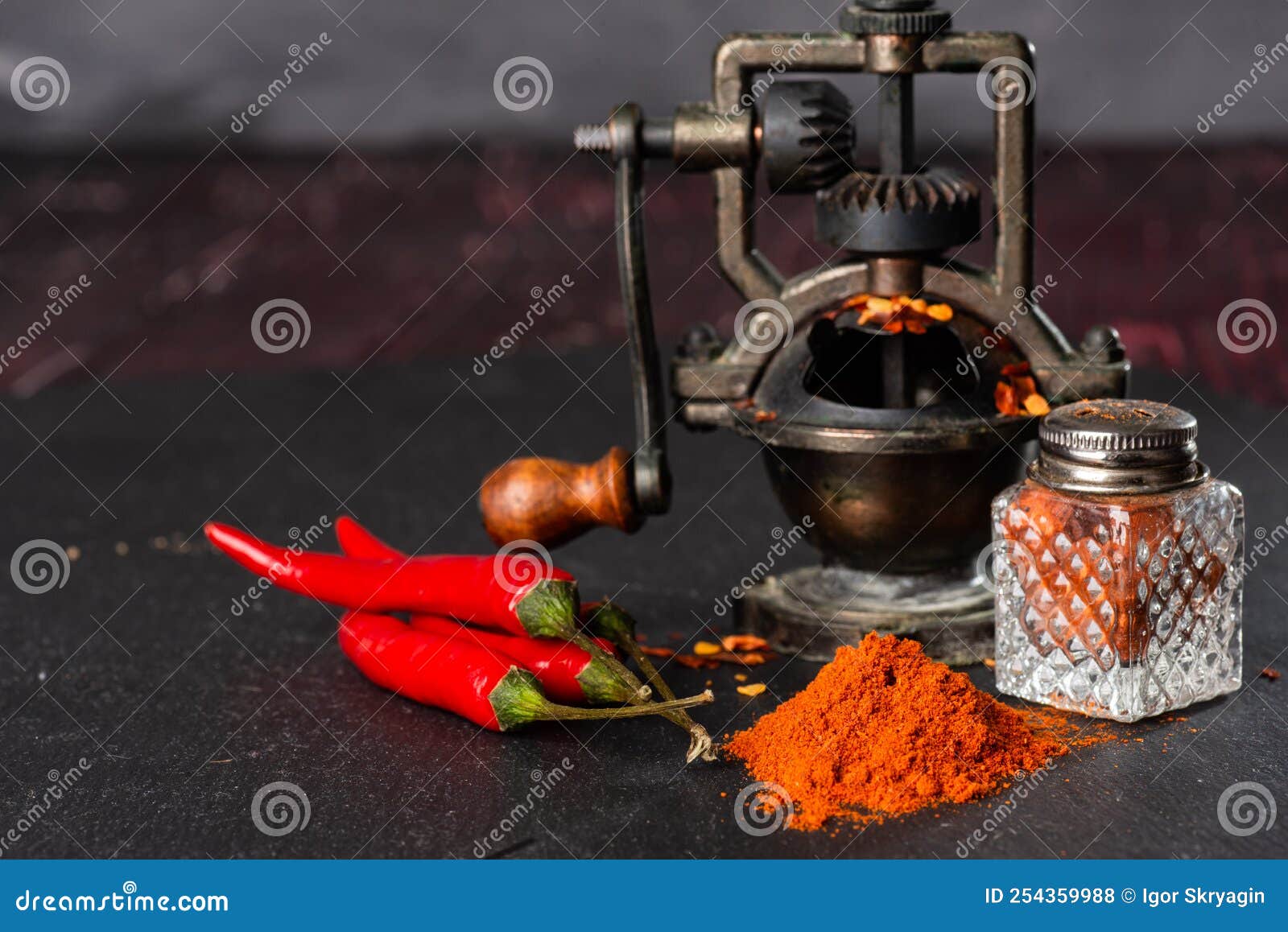 Pepper Mill, a Bunch of Red Peppers, Capsicum and Pepper Pot on a Black