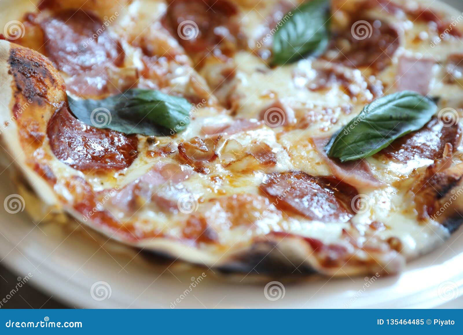 Pepperoni Bacon and Ham Pizza in Restaurant Background Stock Image