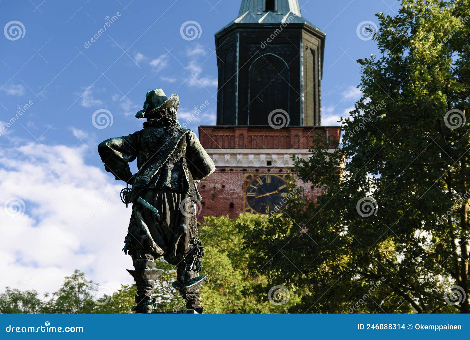 the per brahe statue looking at the tower of turku cathedral, the medieval basilica in finland