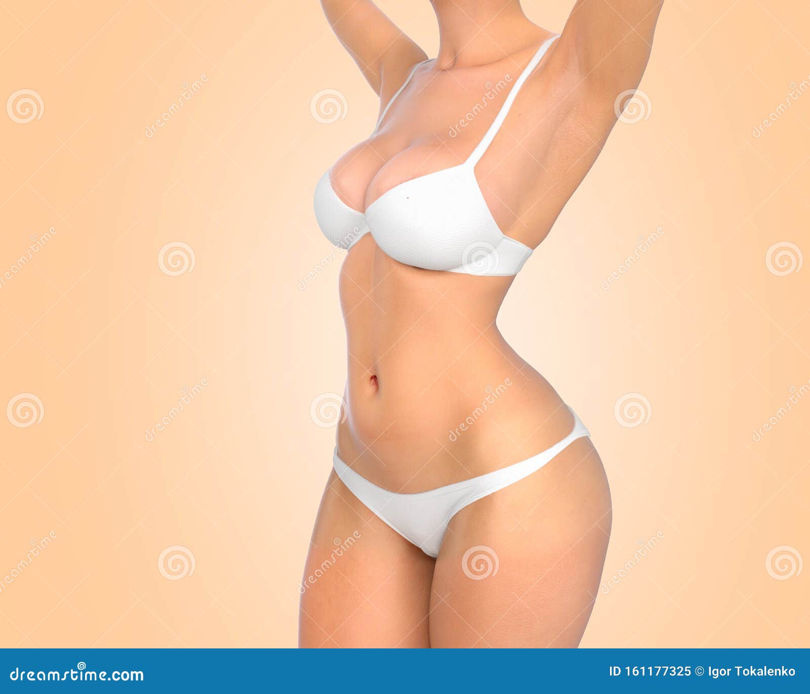 Against white colored background. Woman in underwear with slim