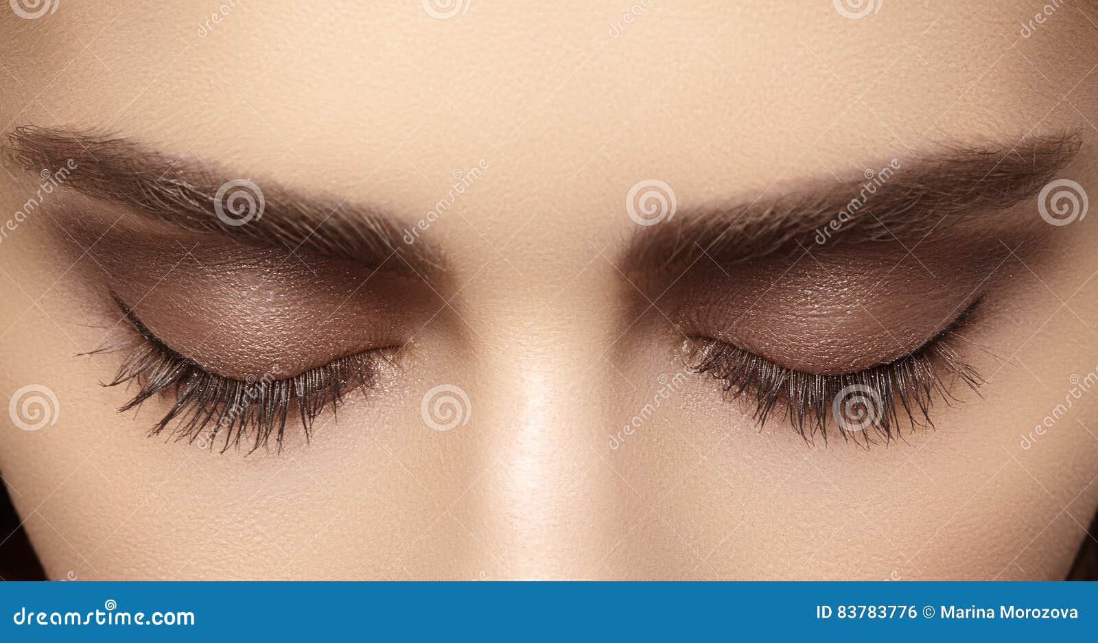 perfect  of eyebrows, brown eyeshadows and long eyelashes. closeup macro shot of fashion smoky eyes visage