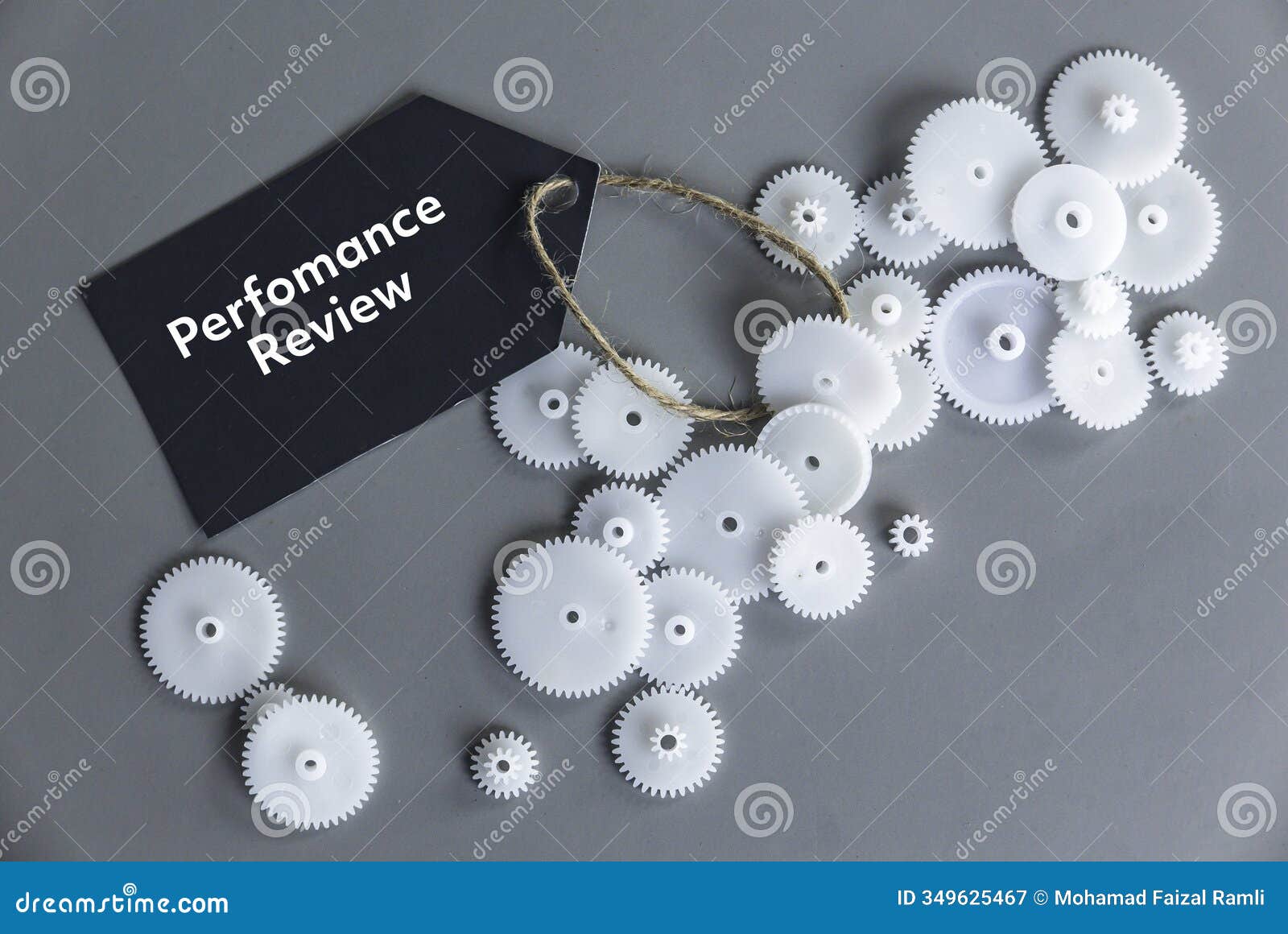 performance review concept with gears and tag on gray background