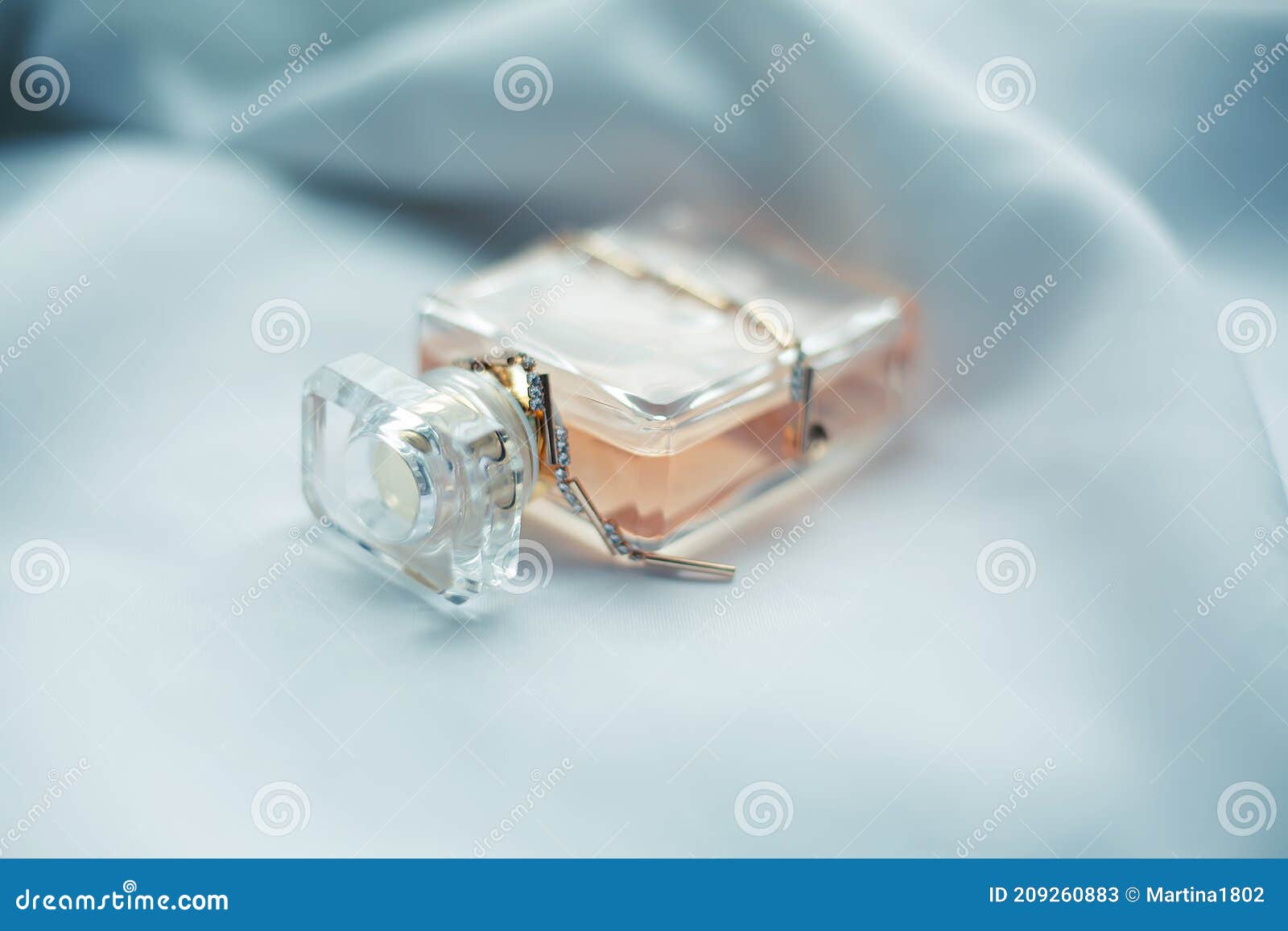Perfume on Background of White Fabric in Waves Stock Image - Image of ...