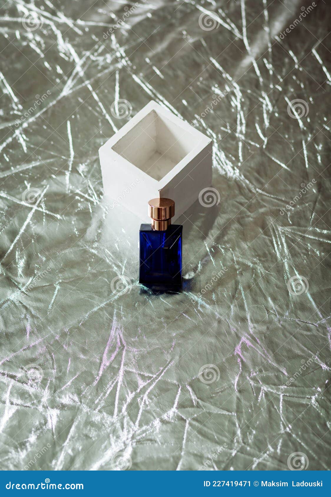 Perfume bottle on cube stock image. Image of elegance 227419471