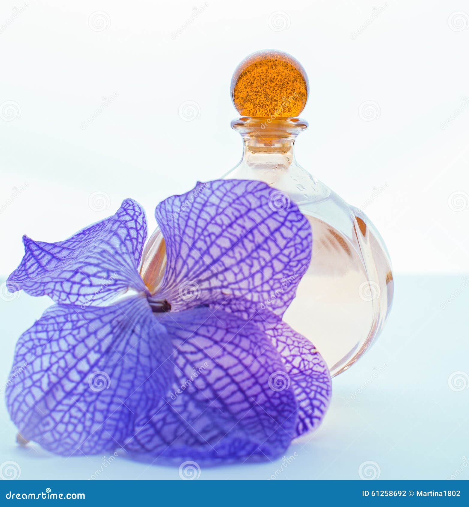 Perfume and purple orchids stock photo. Image of merchandise 61258692