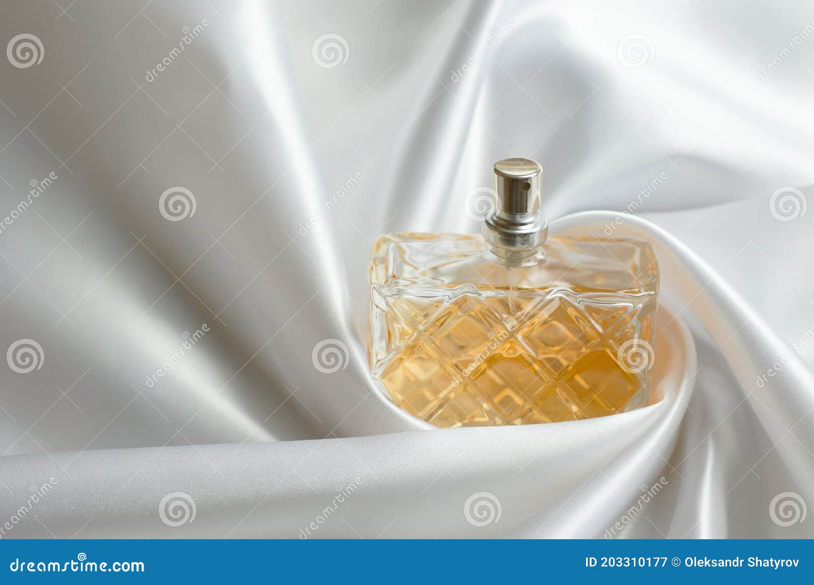Perfume in Silk Fabric. a Bottle of Women S Perfume Wrapped in Wavy Silk Stock Image Image of