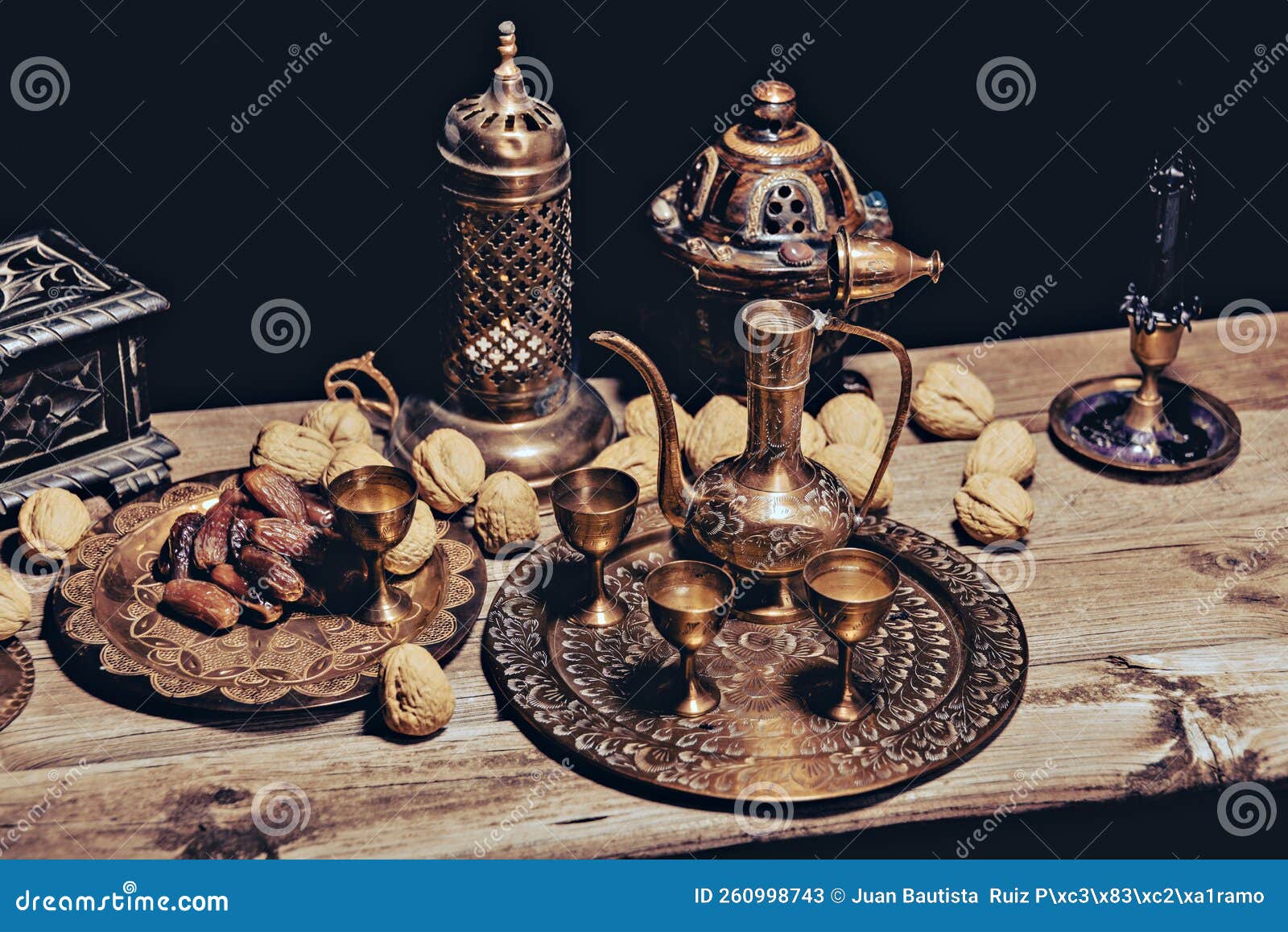 Persian Tea and Teapots Pouring Hot Tea in Tea Cups at a Table. Stock