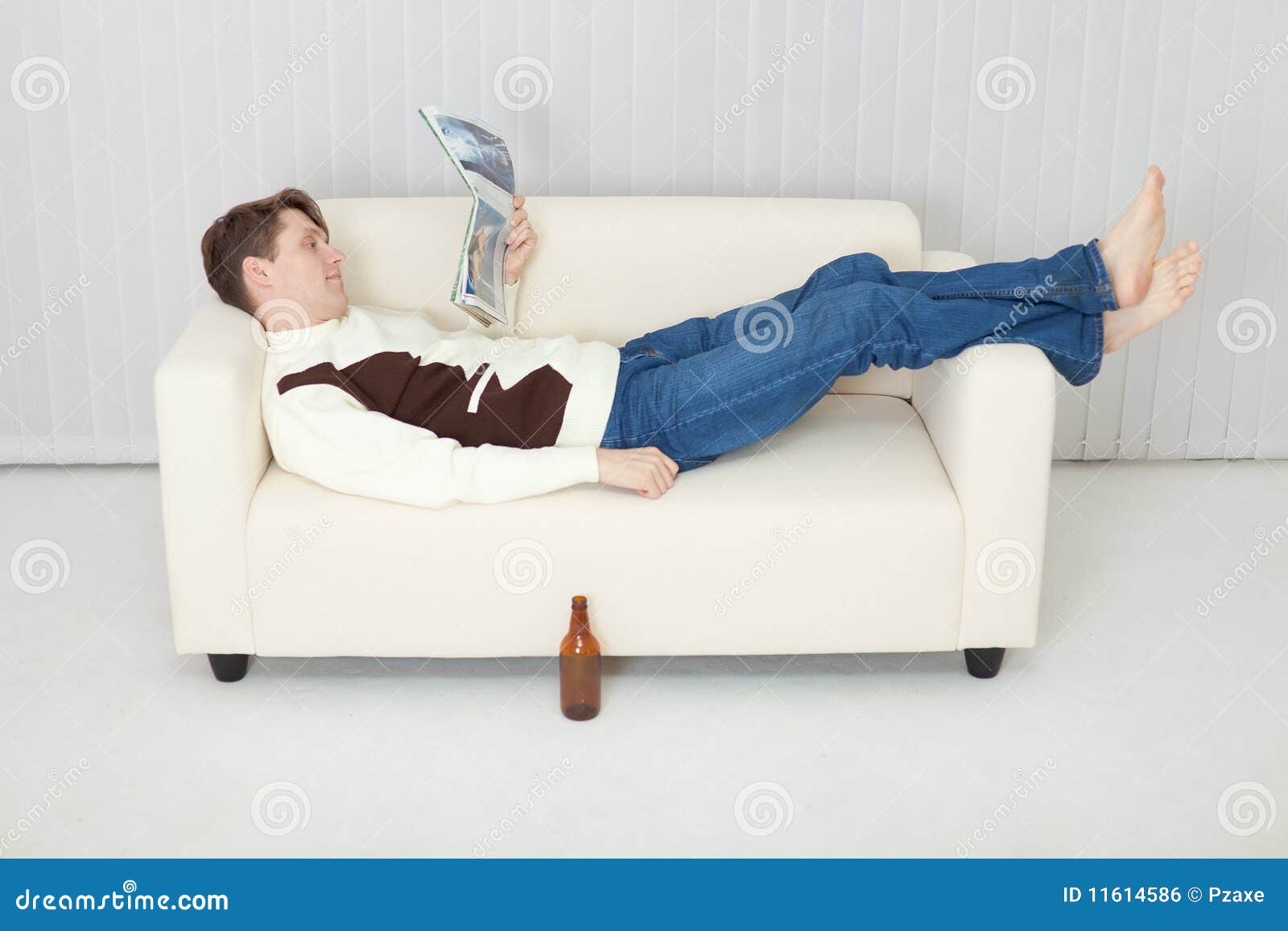 Person Comfortably Lie On Sofa With Journal Stock Photo Image Of