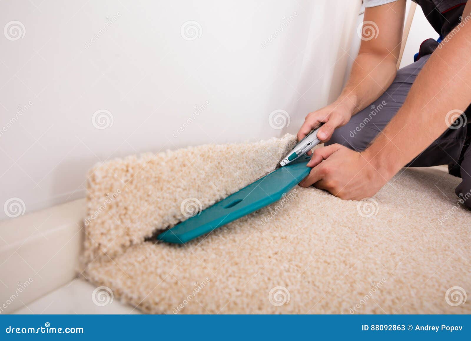 person cutting carpet with cutter