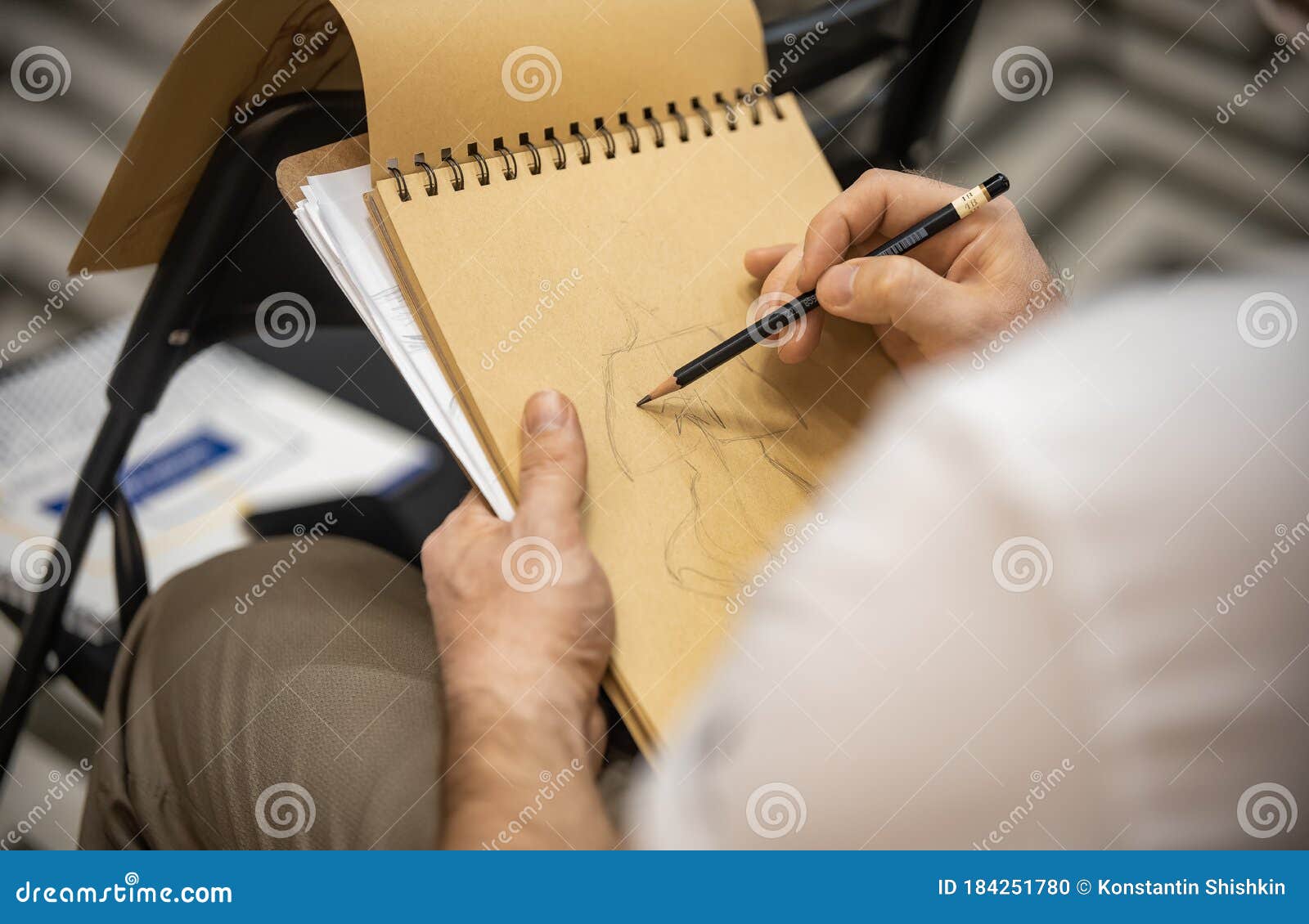 Person Designer Sketching In The Notebook With Yellow 