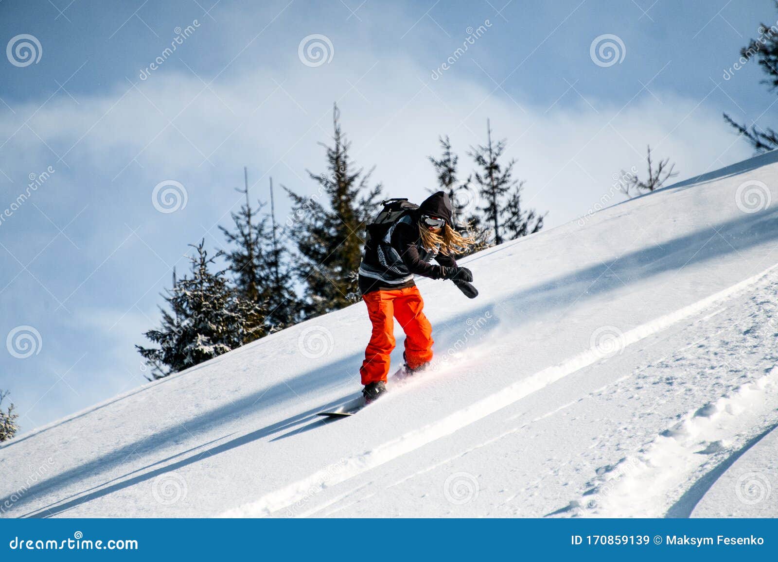 Person with Dreadlocks and in Red Pants Slides Down the Mountainside on ...