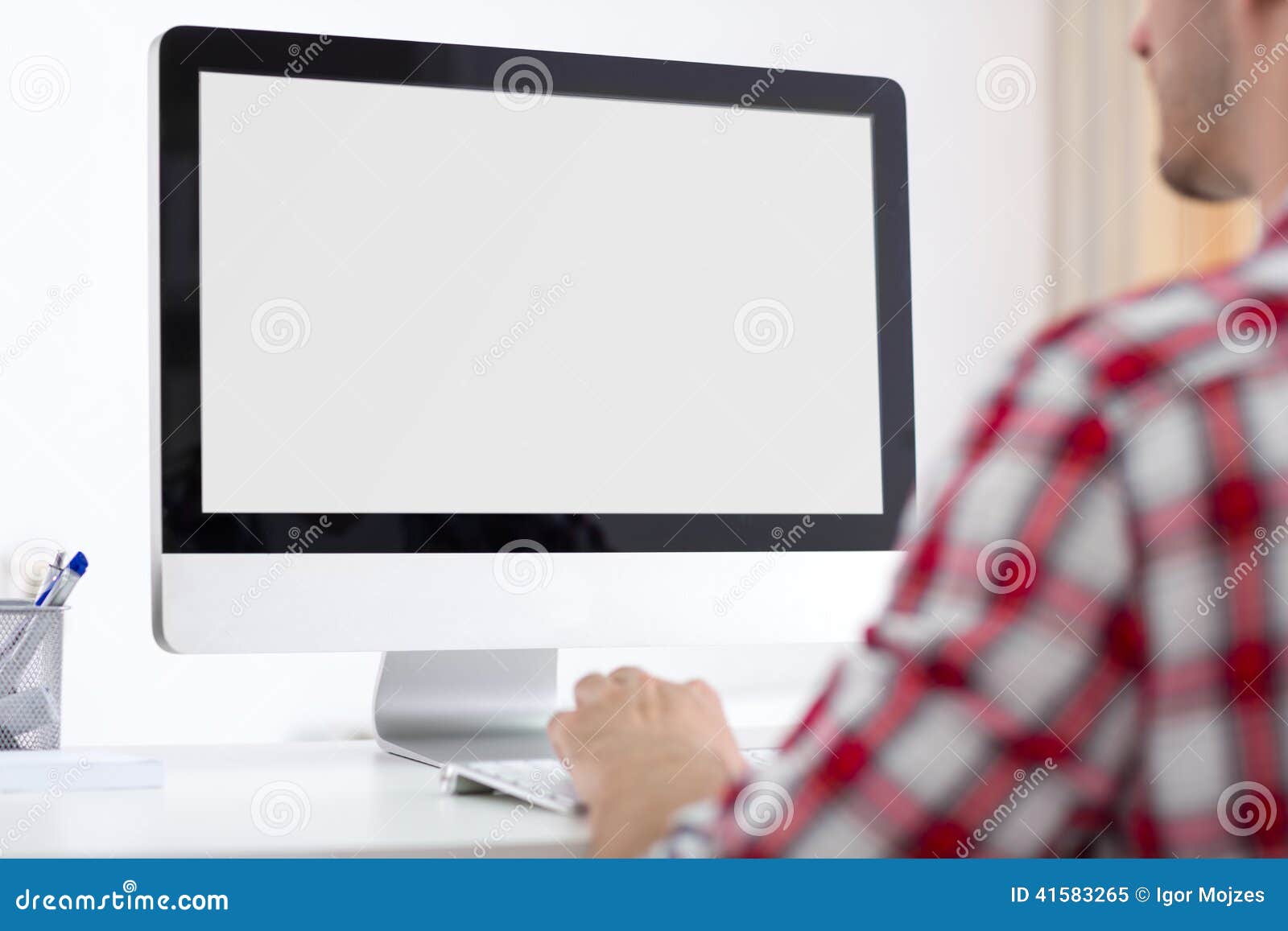 person front of computer monitor