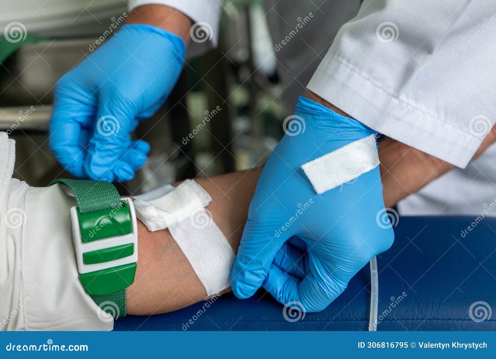 a person in gloves putting a needle on a mannequin.