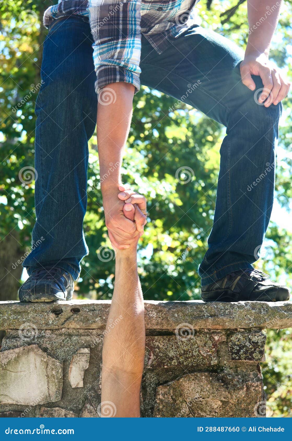 A Person Gripping Another Person S Hand Pulling Them Up from Below