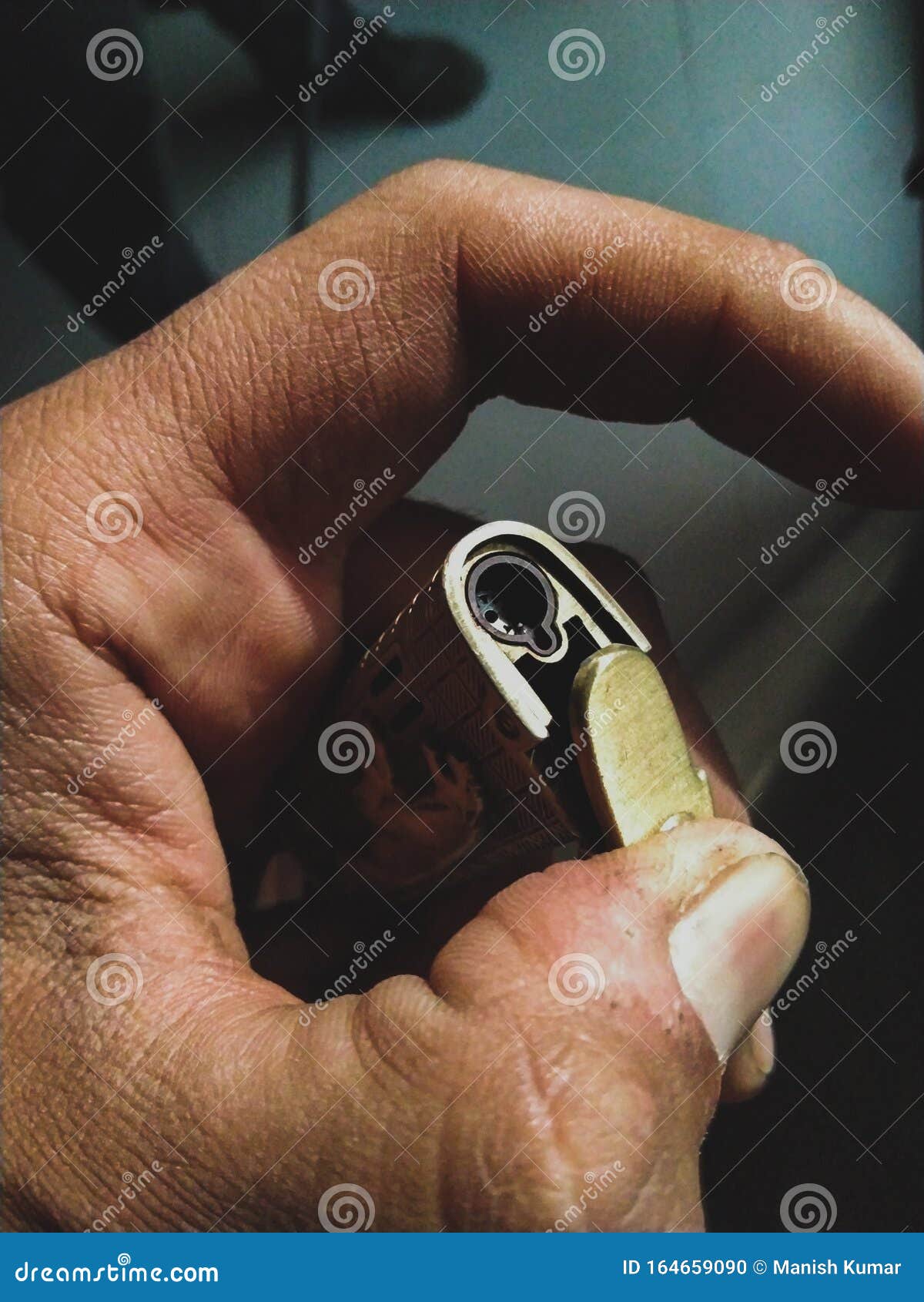 a person holding a golden lighter in his hand