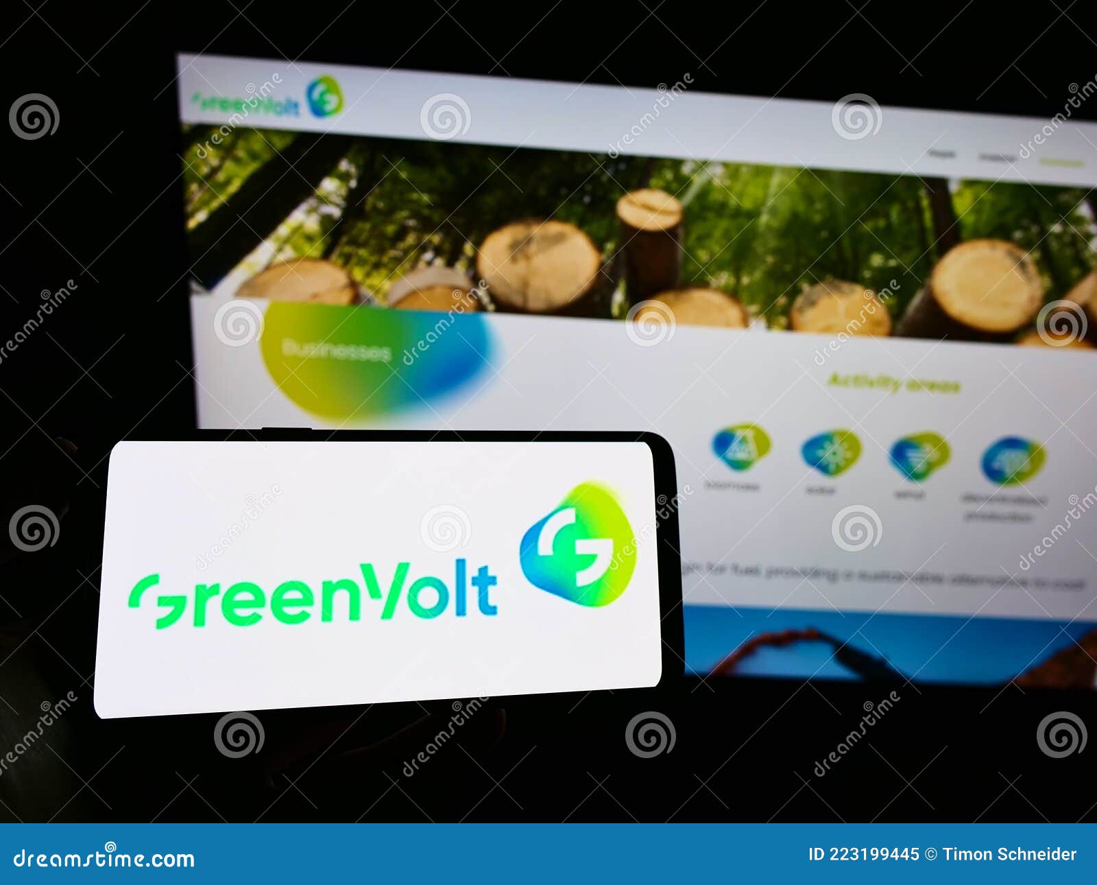 Person holding mobile phone with logo of energy company Greenvolt Energias RenovÃ¡veis SA on screen in front of web page.