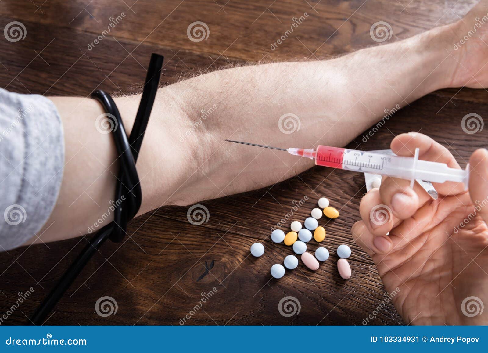 Photo about Close-up Of A Person Hand Injecting Heroin Drug. 