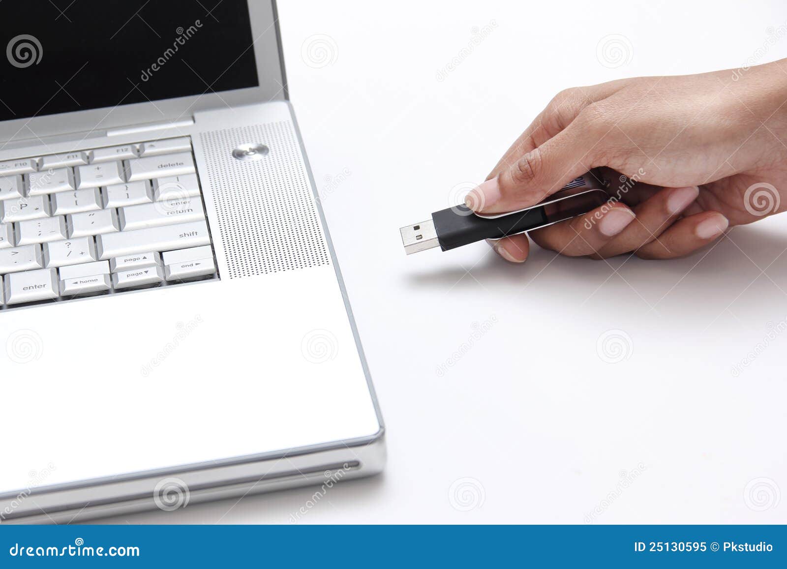 person inserting a usb drive into a laptop