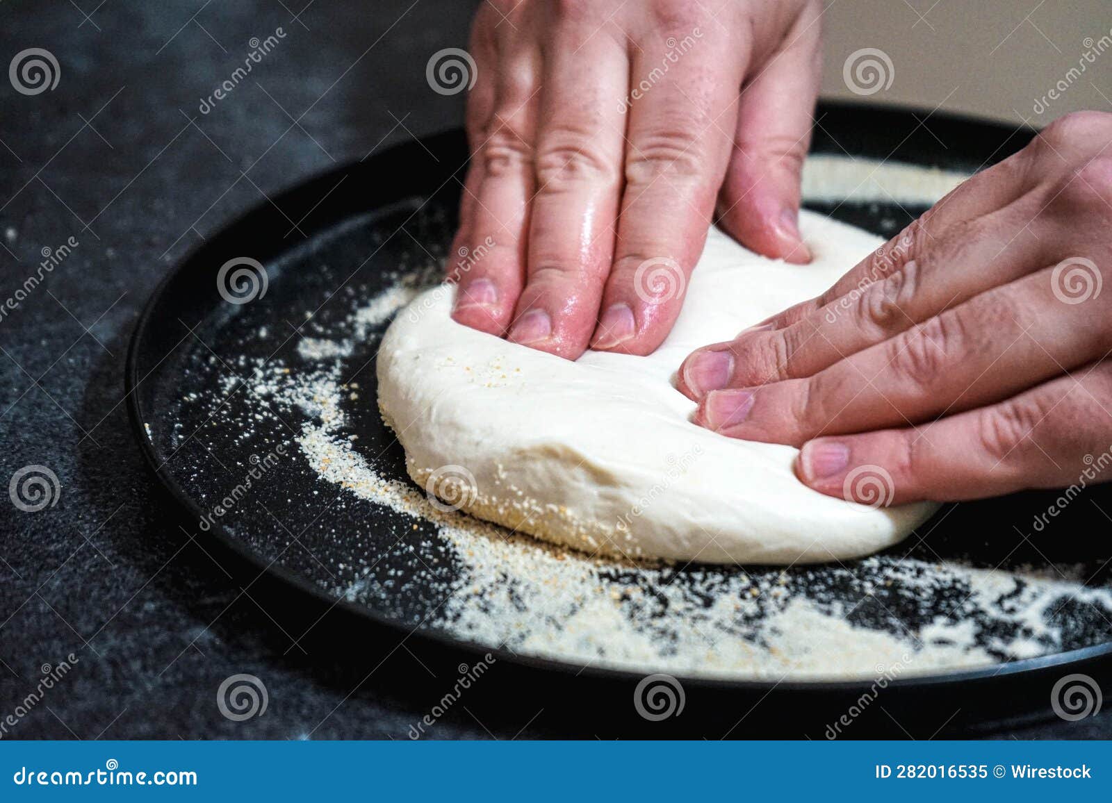 a person is kneads dough out on a plate