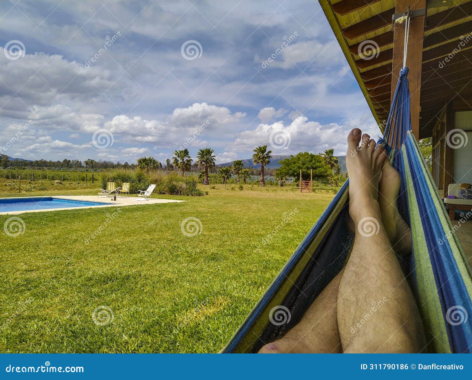 person on paraguayan hammock at countryside landscape