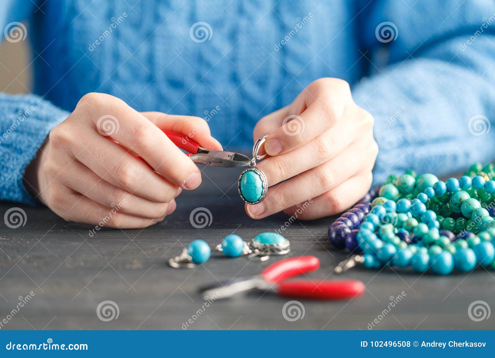 Person Making Jewelry Using Wire, Chains and Beads and Other Materials with Craft Tools Stock