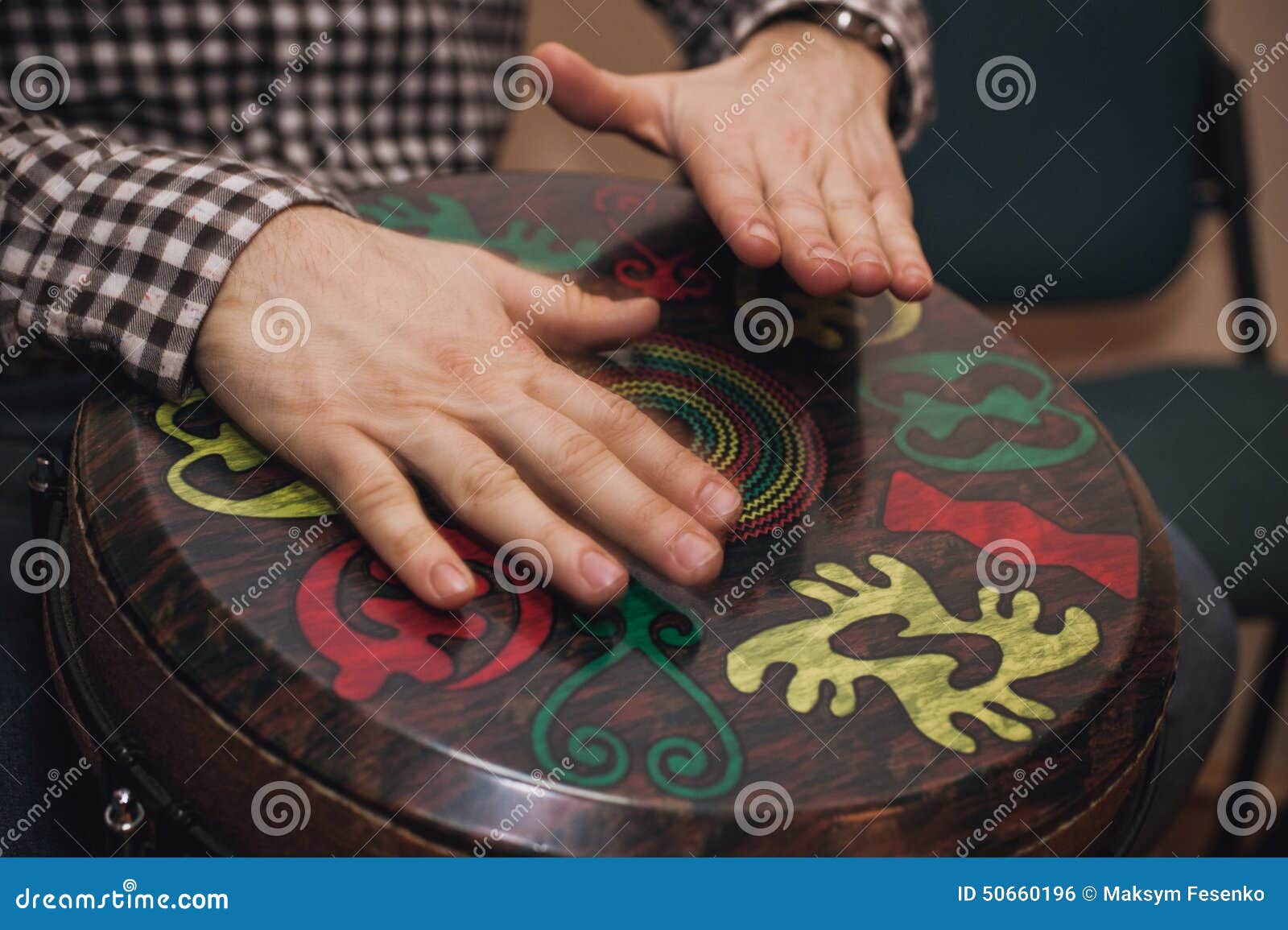person playing on jambe drum no face