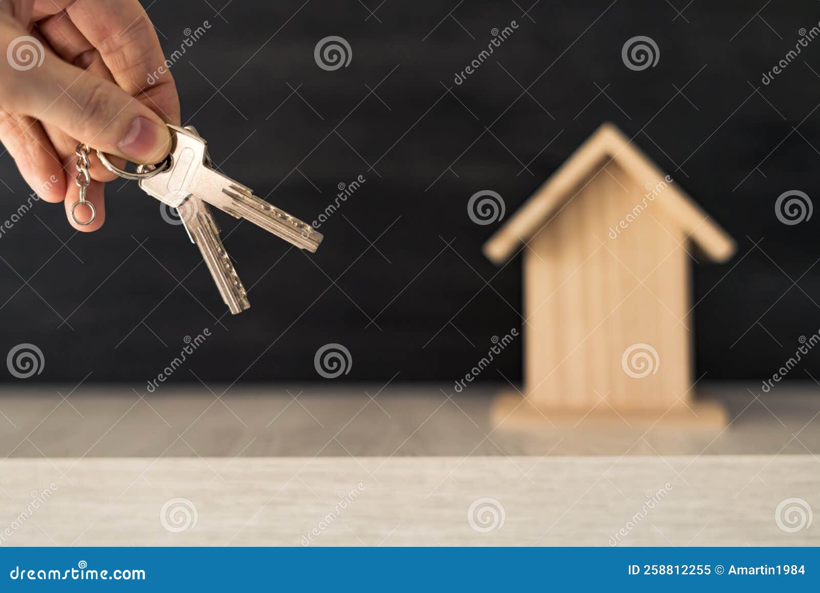 A Person S Hand Holding the Keys To Their New Home Ownership with Small