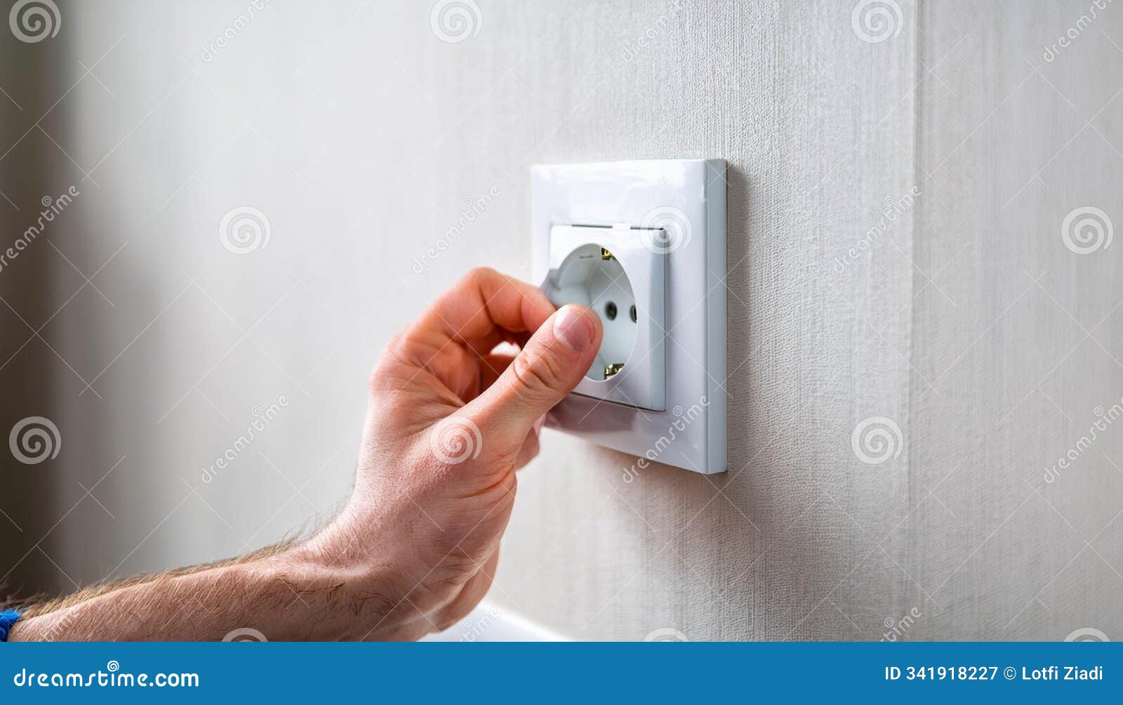 person's hand installing socket on wall