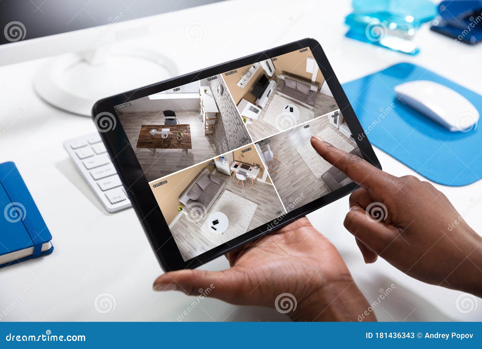 person`s hand monitoring cctv footage on tablet