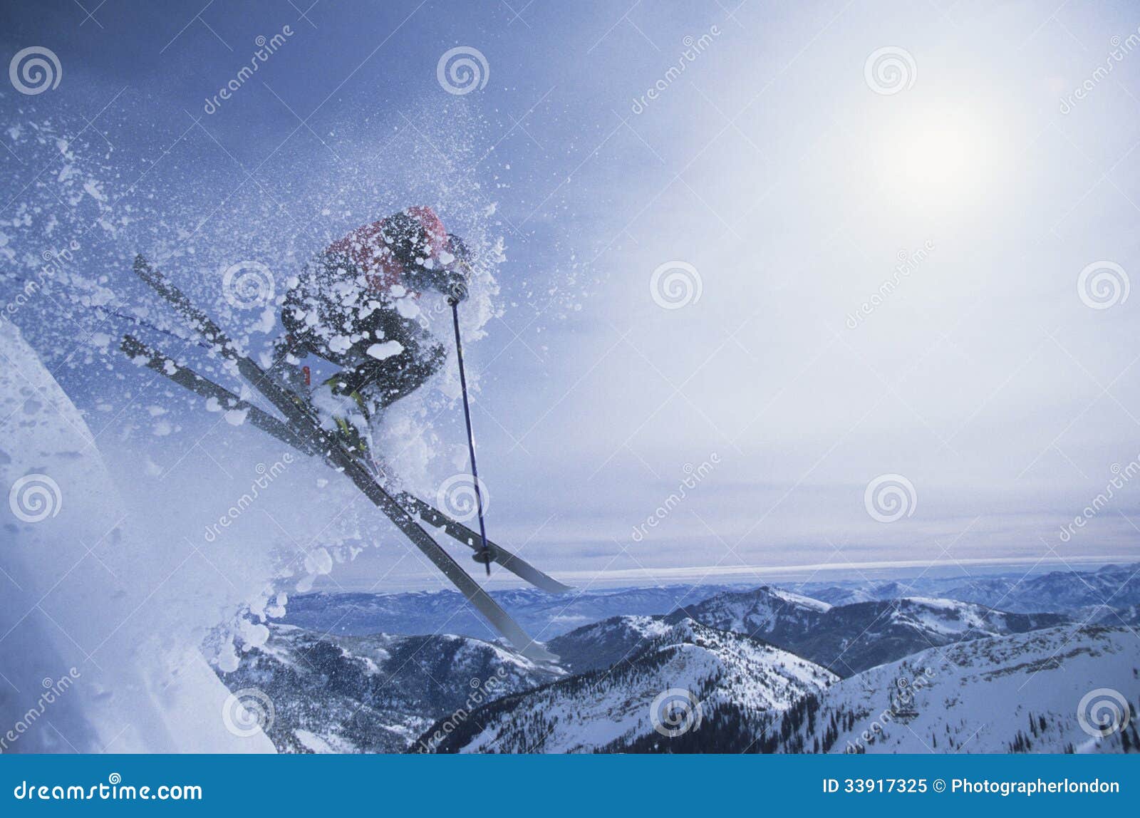 Side view of a person on skis jumping over slope