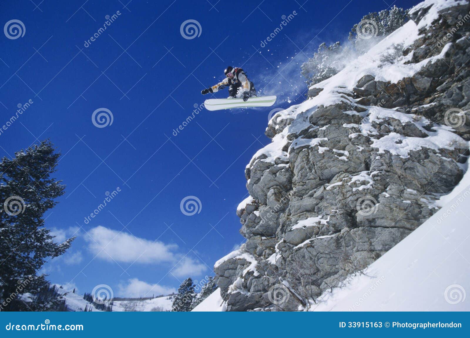 person on snowboard jumping midair