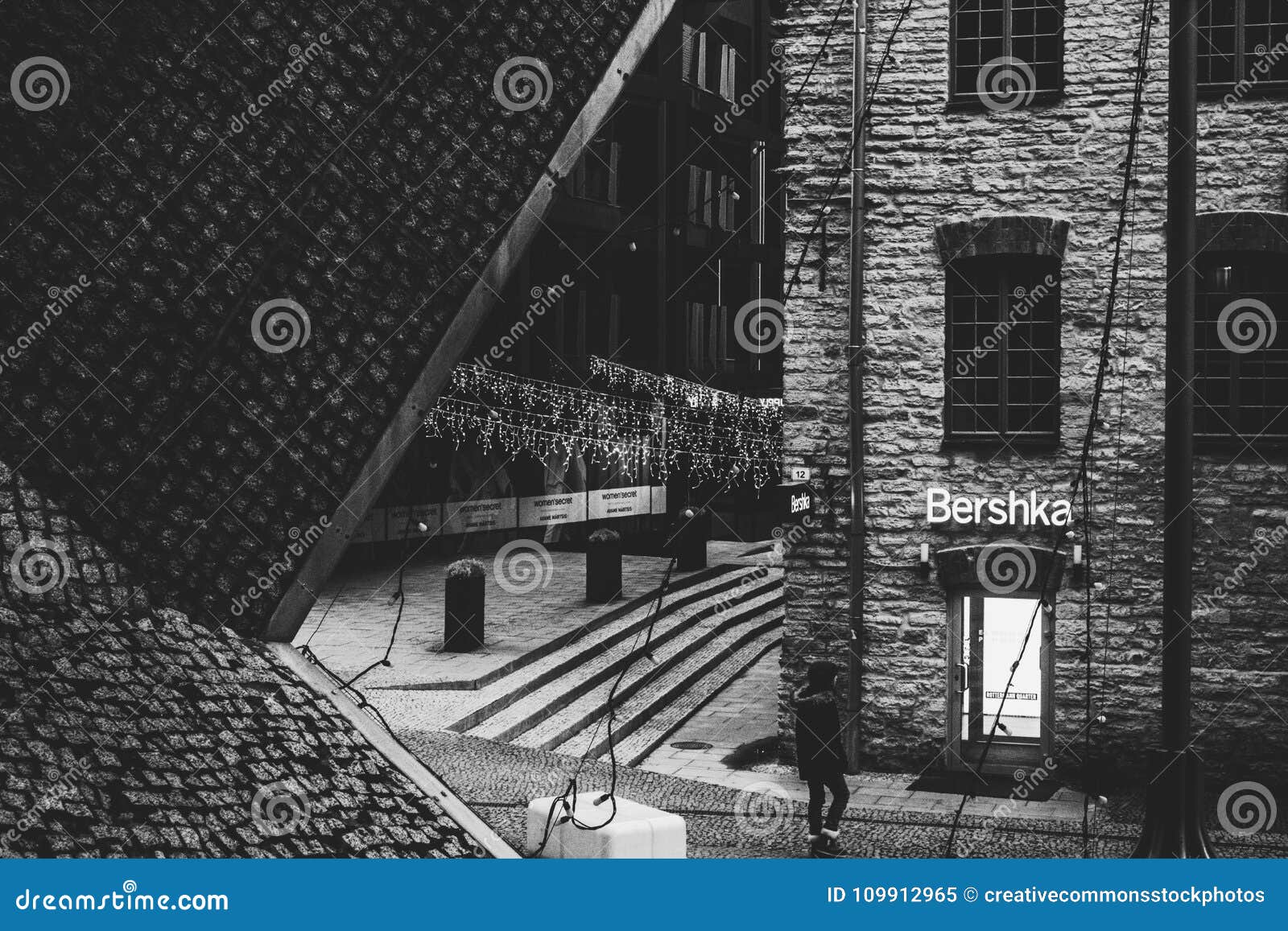 Grayscale photo of man standing near window photo – Free Cloud