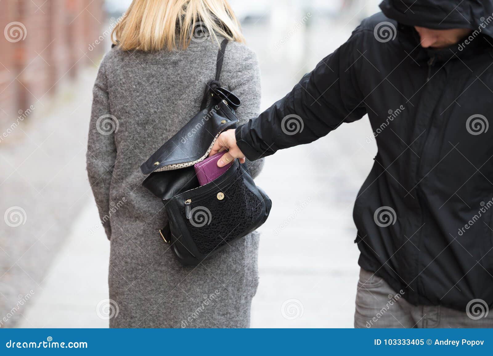 person stealing purse from handbag
