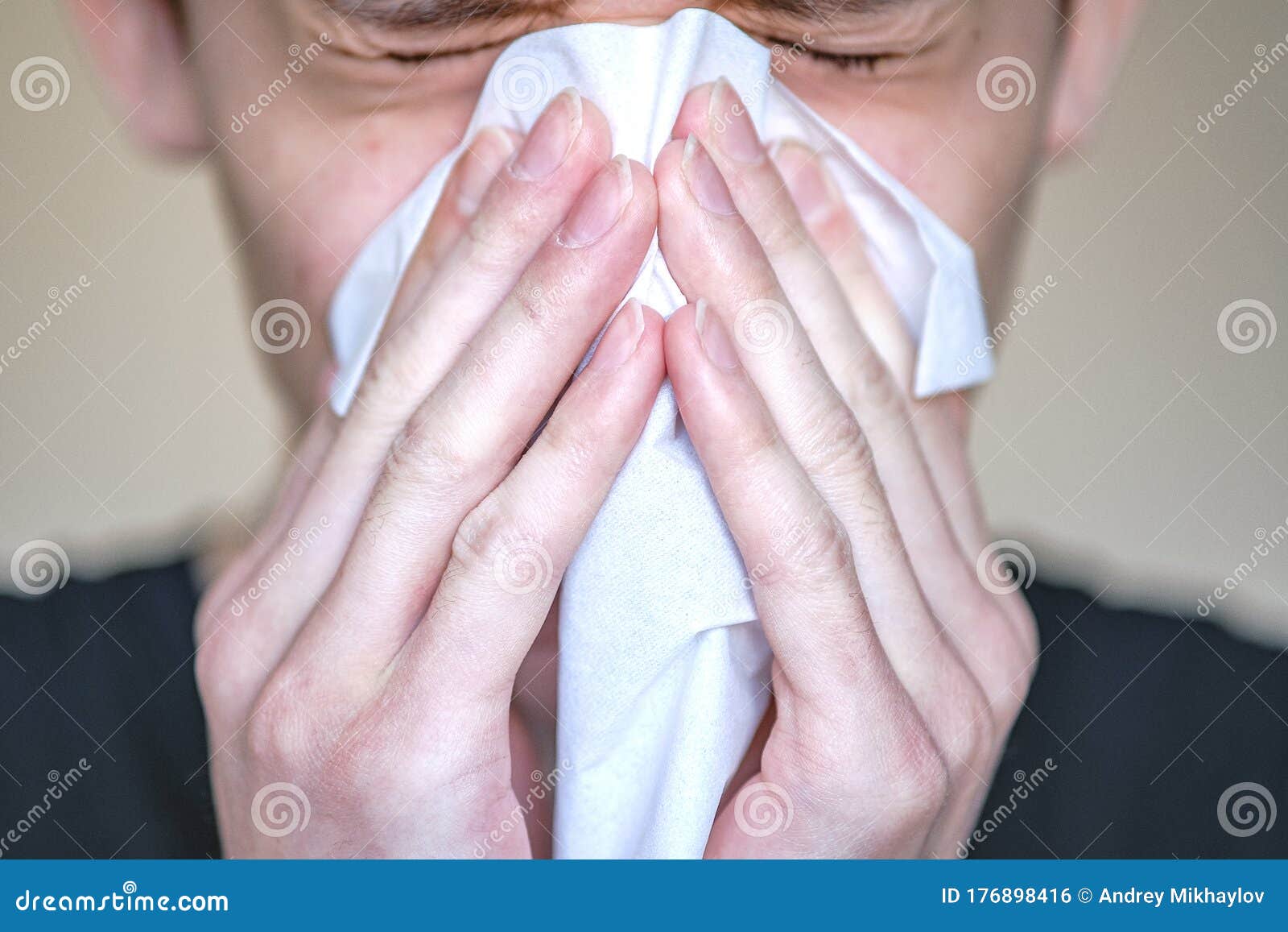 a person with symptoms of the disease presses a handkerchief to his face. sneezing, bouts of coughing