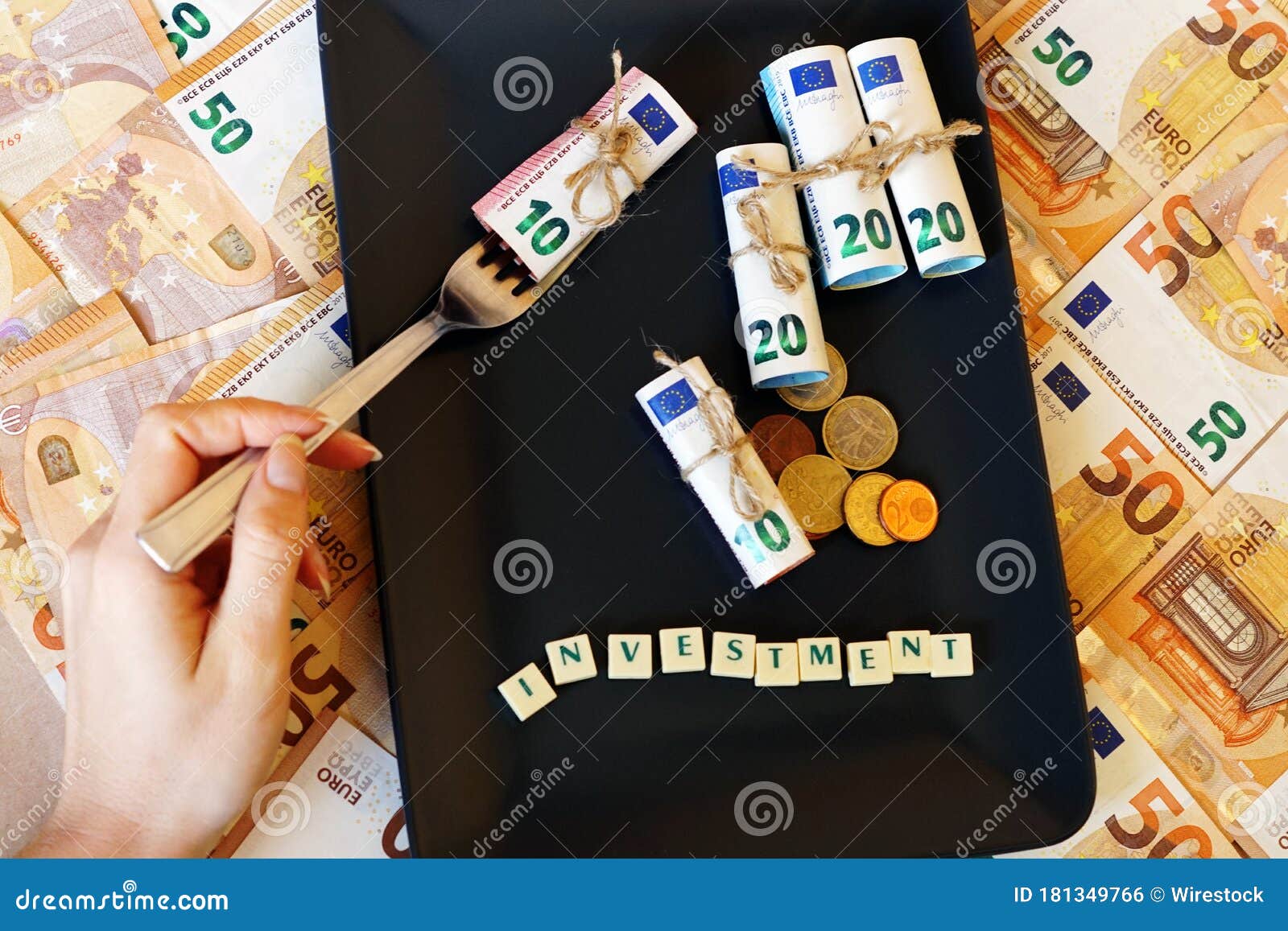 person taking dinero bills with a fork out of the plate - investment concept