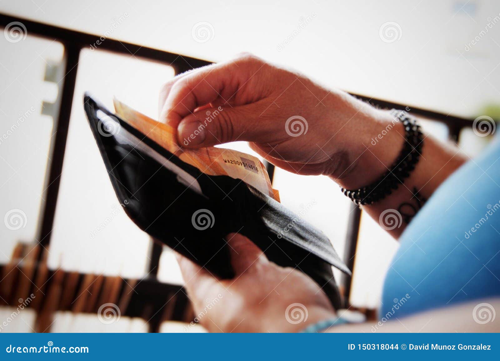 person taking money out of his wallet.