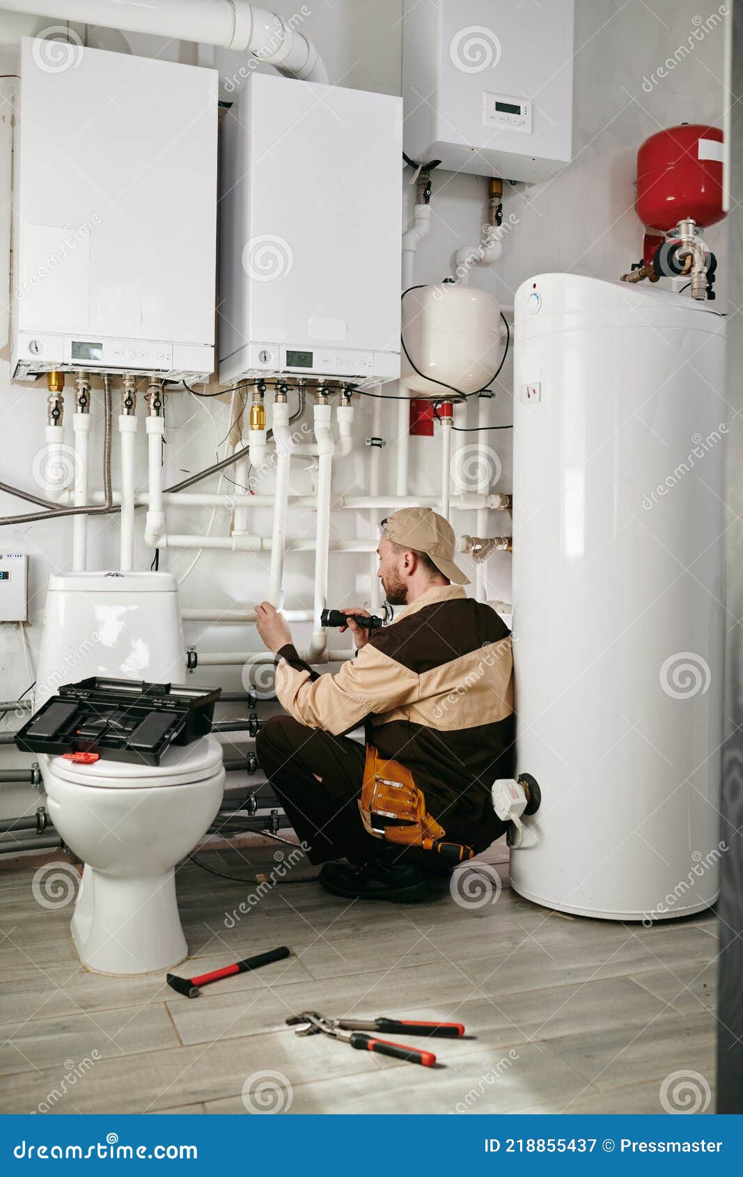 A Person in Toilet Using Handtools during Repairing Work Stock Image