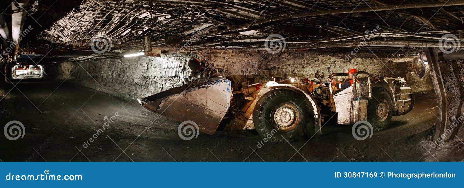 person in unconventional car in tunnel side view