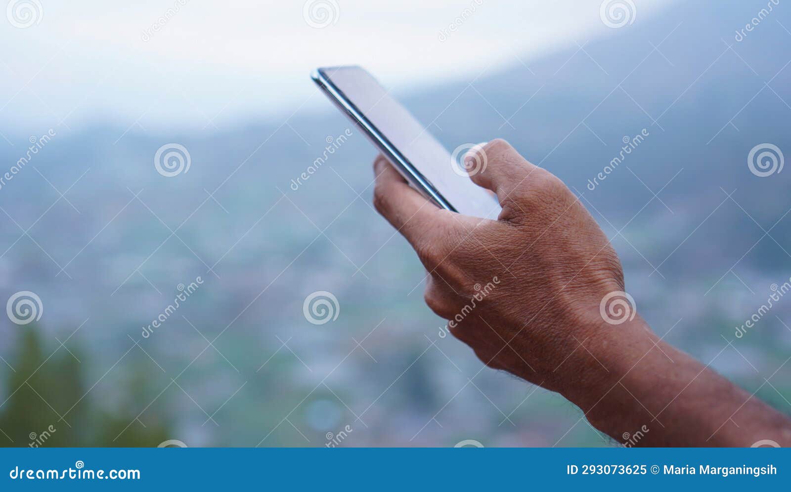 person using mobile phone. closeup of businessman holding phone in hand, checking news or messages on a vacation.