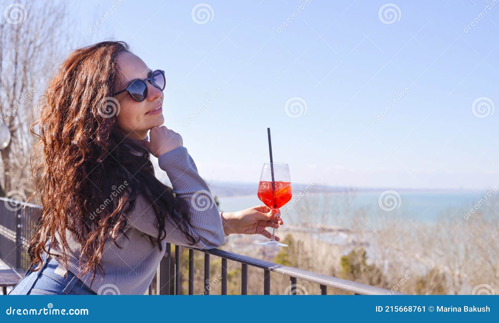 A Person Wearing Glasses Holding a Glass of Wine Posing for the Camera ...