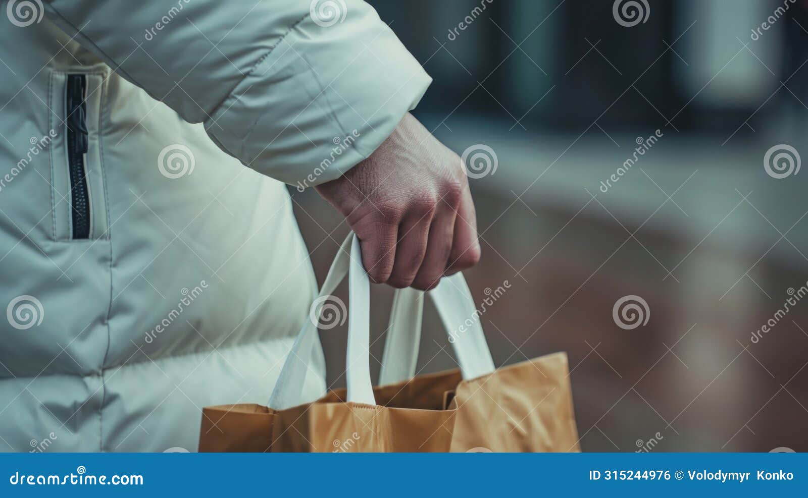 person in white coat holding brown bag, practical and professional image