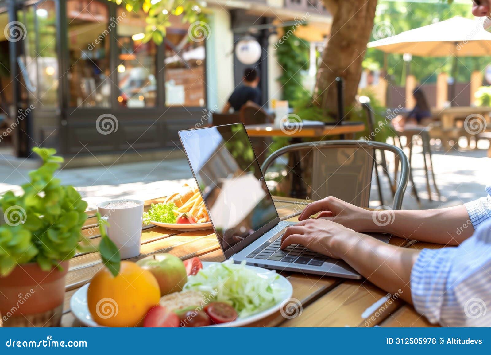 person working on laptop in outdoor caf setting