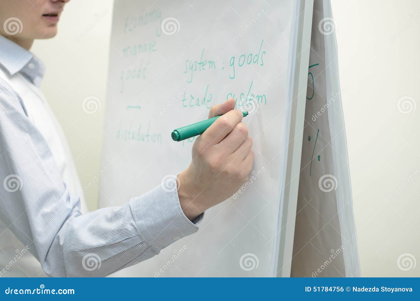A Person Writing on Flip Chart Desk. Stock Photo Image of adult