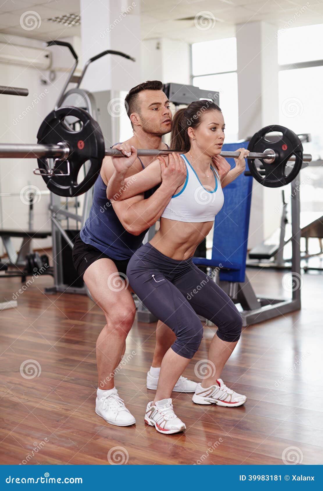 Personal Trainer Helping Woman at Gym Stock Image - Image of power