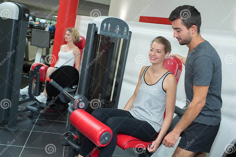 Personal Trainer Helping Women Working Out in Gym Stock Image - Image ...