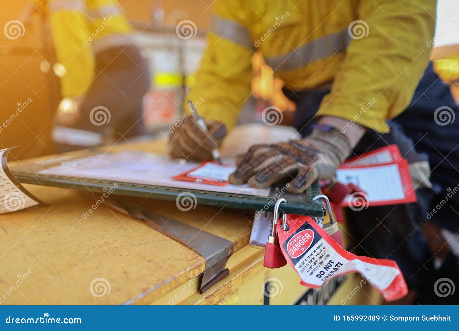 personnel red danger locks attached with danger tags are locking on safety isolation permit lock box