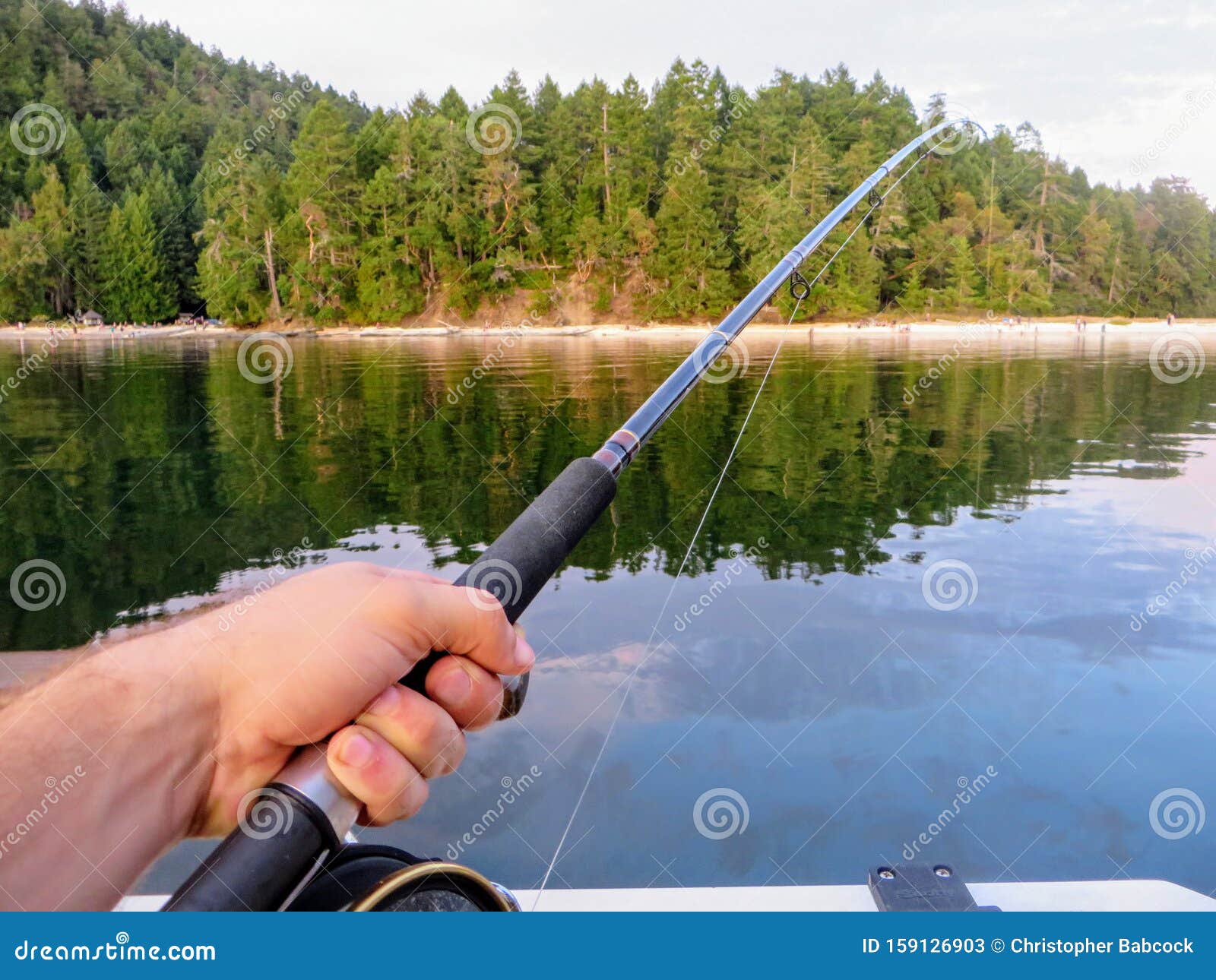 Perspective from a Boat of a Man Hand Holding a Fishing Rod